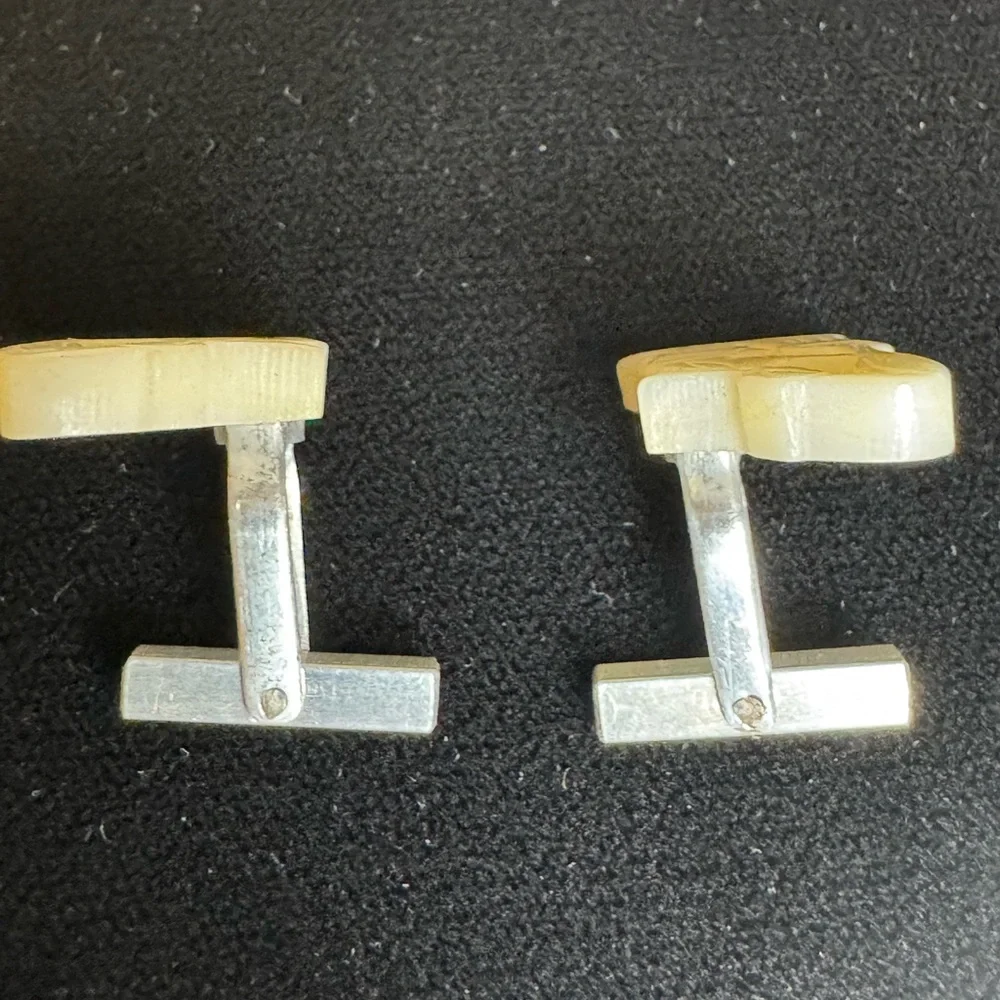 Vintage men’s carved mother of pearl cufflinks of women pouring grain